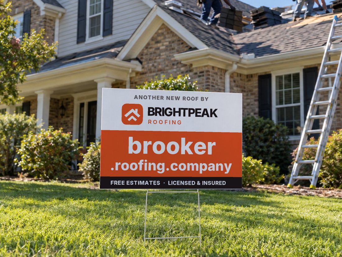 brooker.roofing.company on a yard sign in front of a house getting a new roof